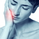 woman with tooth pain in need of emergency dental care